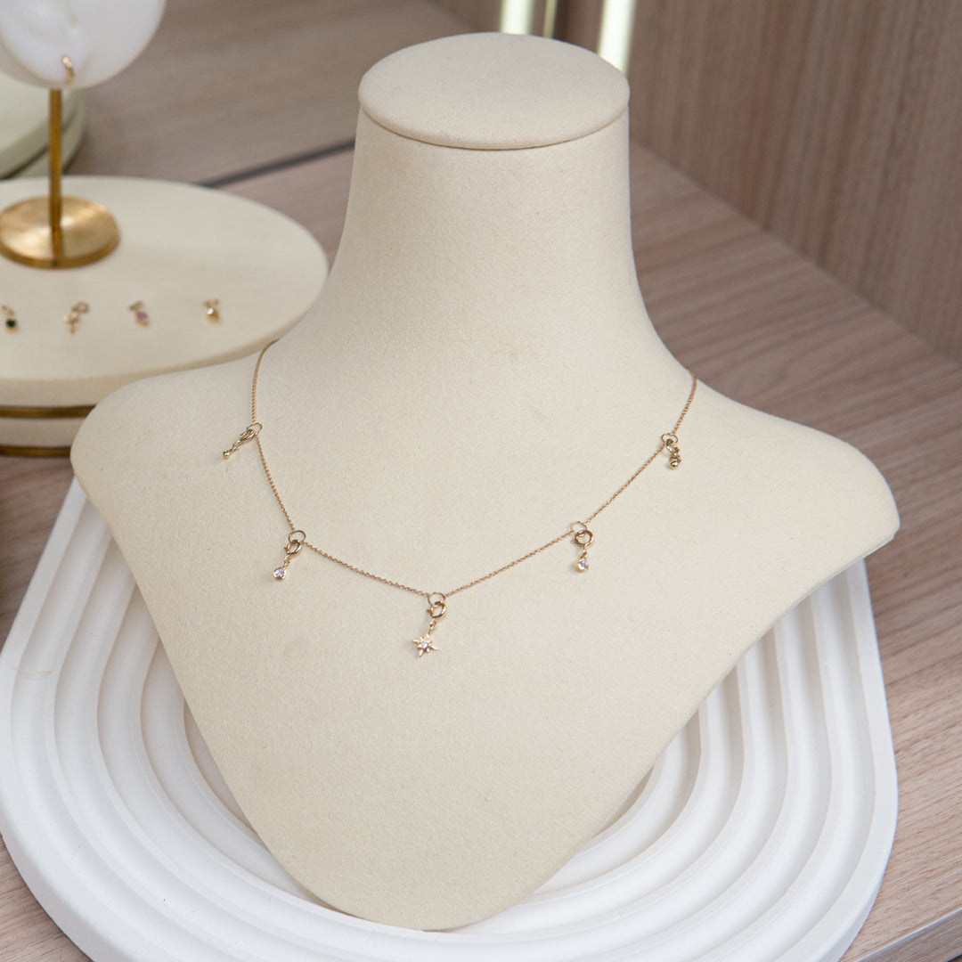 14K Yellow Gold necklace with 5 charms and movable lock on display at Stellar Malaysia