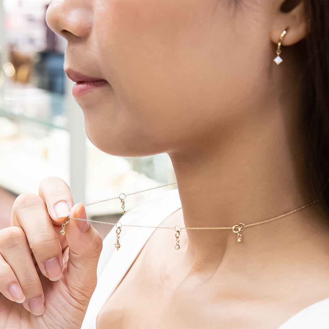 4K Yellow Gold necklace with 5 charms, worn by model, available at Stellar Malaysia